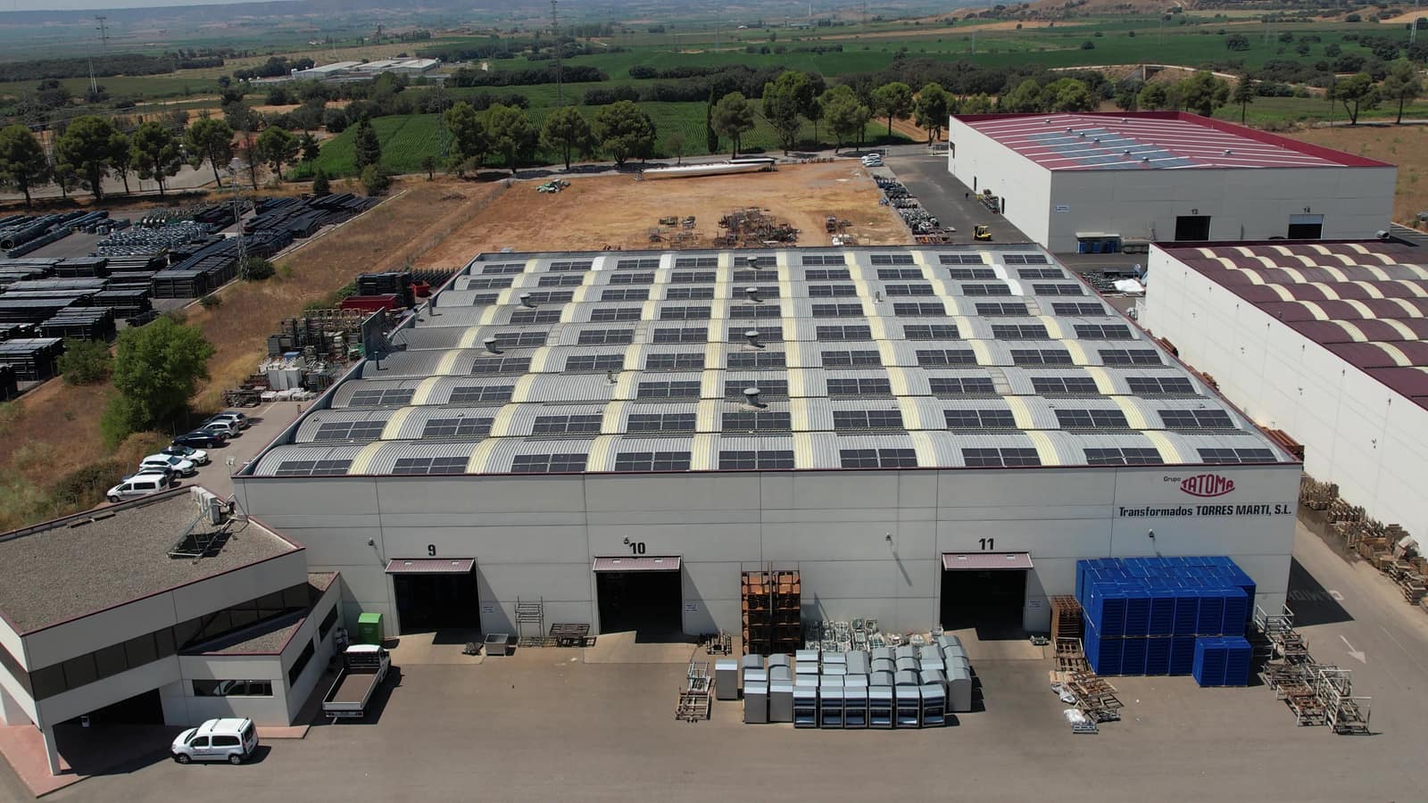 Vista aérea con dron de una nave industrial con placas solares en la cubierta